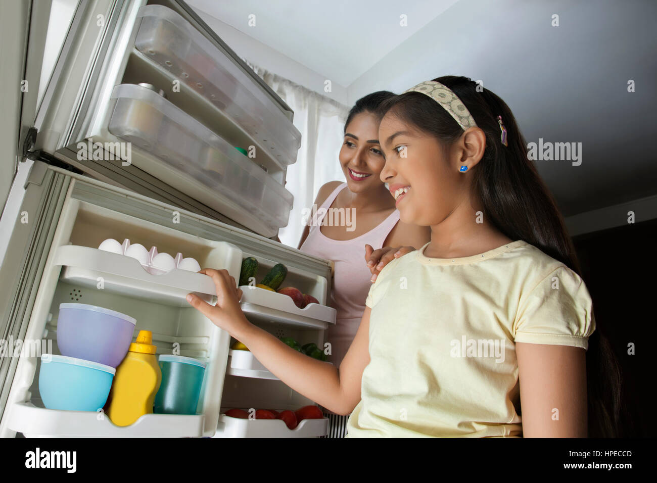 Close-up di la figlia e la madre cercando nel frigo Foto Stock
