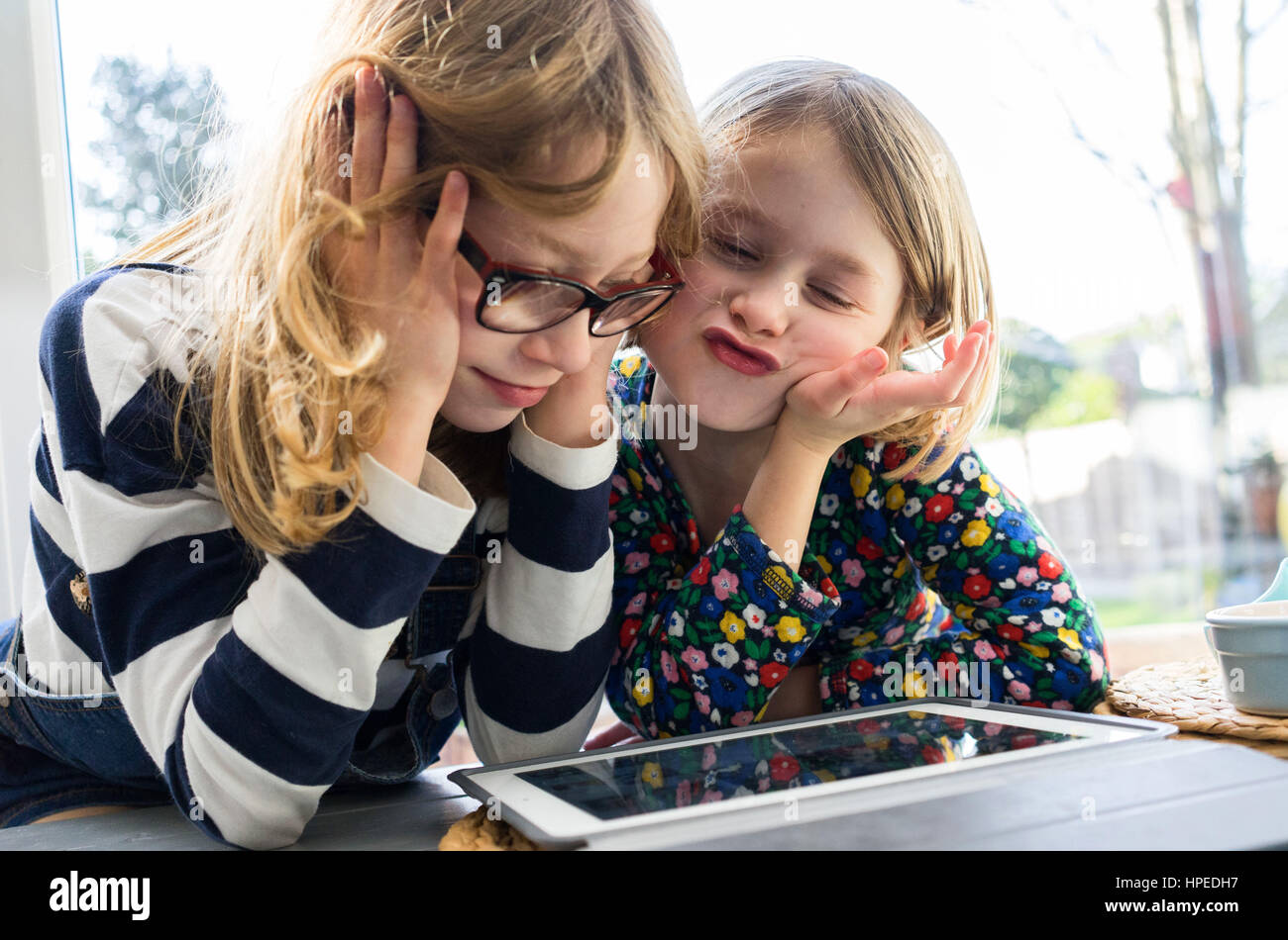 Ragazze su tablet a casa Foto Stock