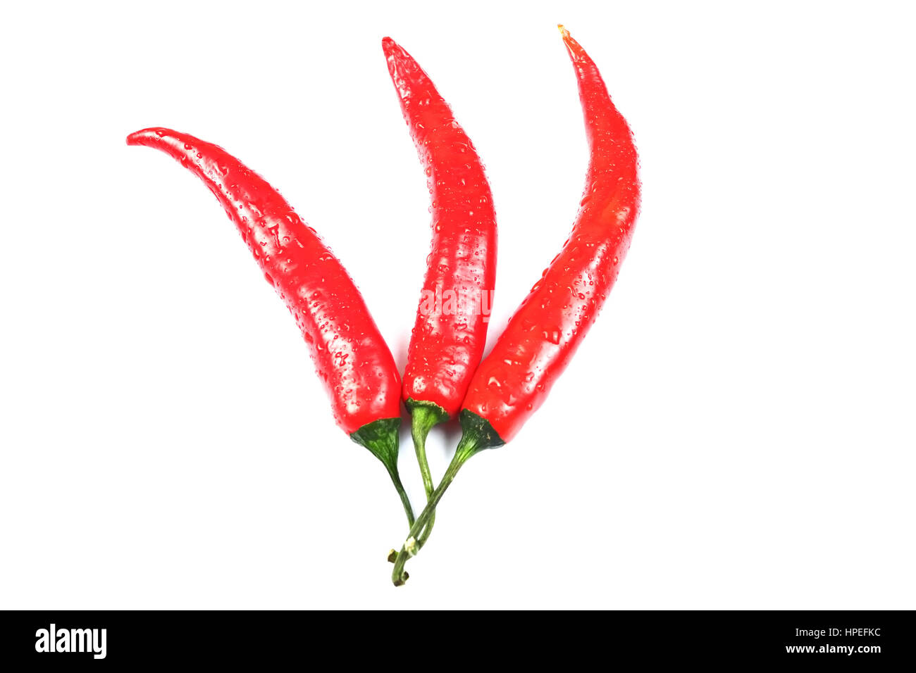 Tre red hot chili peppers isolati su sfondo bianco Foto Stock
