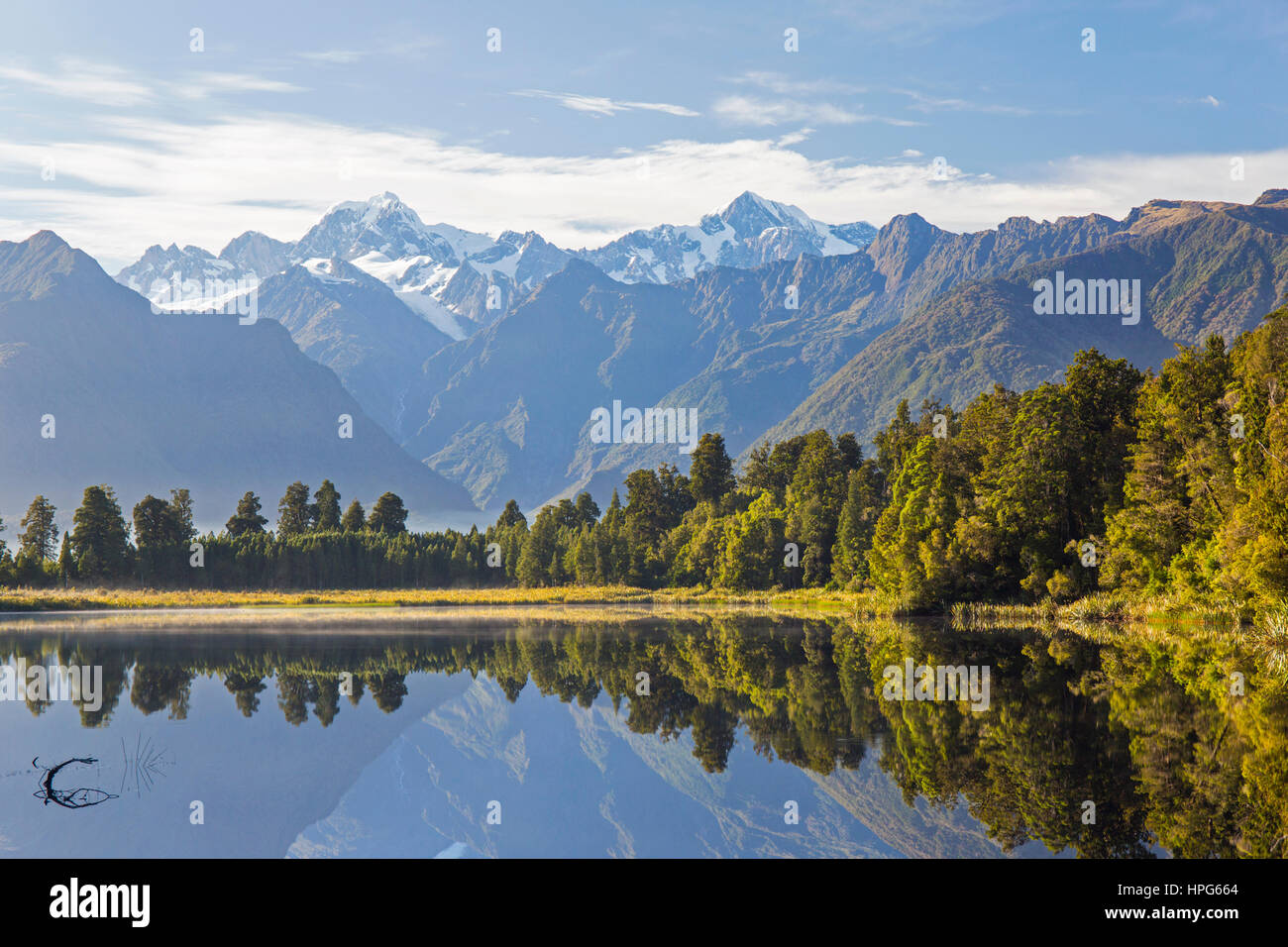 Fox Glacier, Westland Tai Poutini National Park, West Coast, Nuova Zelanda. Vista sul tranquillo Lago Matheson a Mount Tasman e Aoraki/Mount Cook. Foto Stock