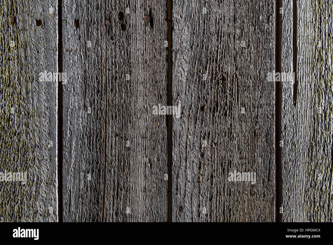Il telaio di legno scuro dello sfondo con assi verticali Foto Stock
