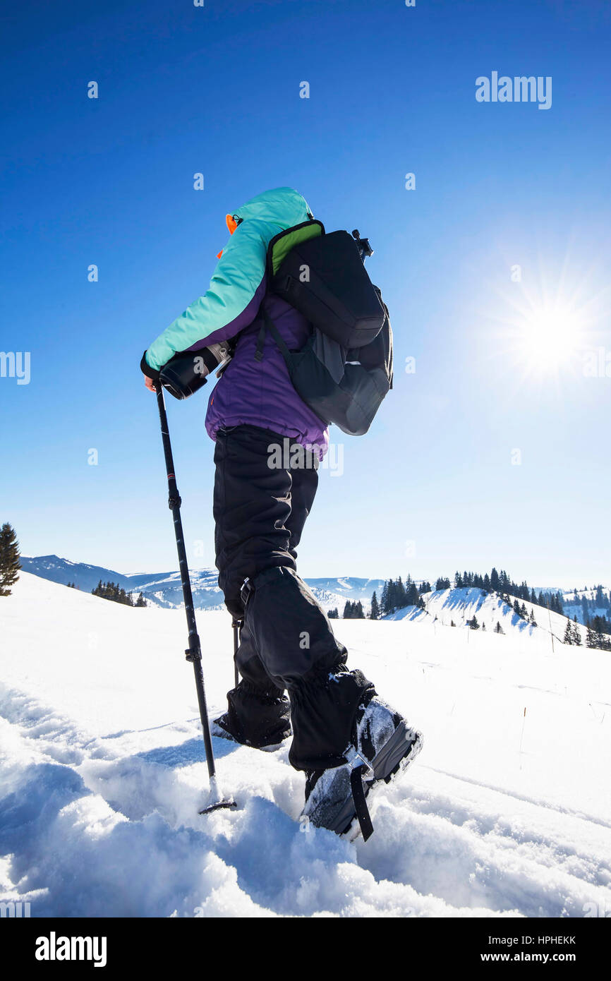 Inverno in dotazione alpinista con bastoncini da trekking sulla neve il percorso Foto Stock