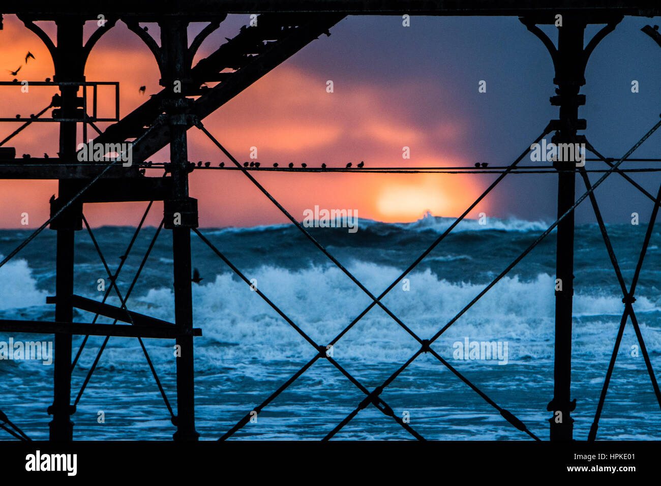Aberystwyth, Wales, Regno Unito. 23 feb 2017. Regno Unito Meteo: uno spettacolare tramonto dietro il molo a Aberystwyth dopo il giorno-lomg assalto di Storm Storm Doris Doris era il quarto denominato storm dell'inverno ed è stato classificato come un "meteo bomba' (esplosiva cyclogenesis) dal Met Office Photo credit: Keith Morris/Alamy Live News Foto Stock