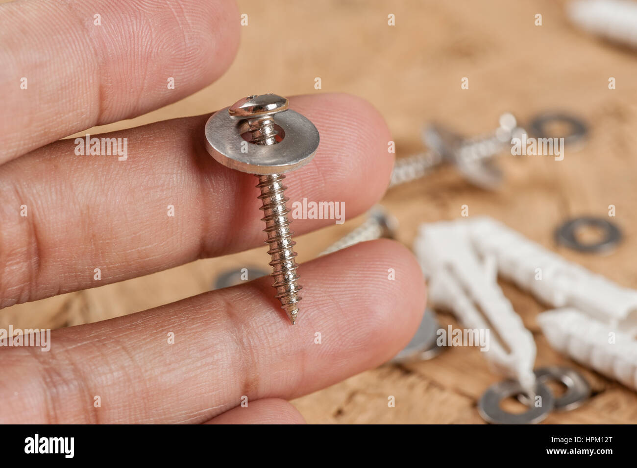 Closeup vite con vite tampone la rondella in mano Foto Stock