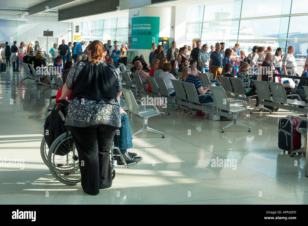 Donna obesa e uomo in carrozzella attendere a bordo di un volo Ryanair presso l'aeroporto di Dublino, Irlanda Foto Stock