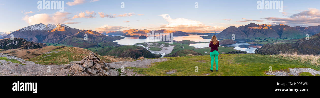 Tramonto, escursionista affacciato sul lago Wanaka, picco roccioso, picco roccioso Park, Otago Southland, Nuova Zelanda Foto Stock