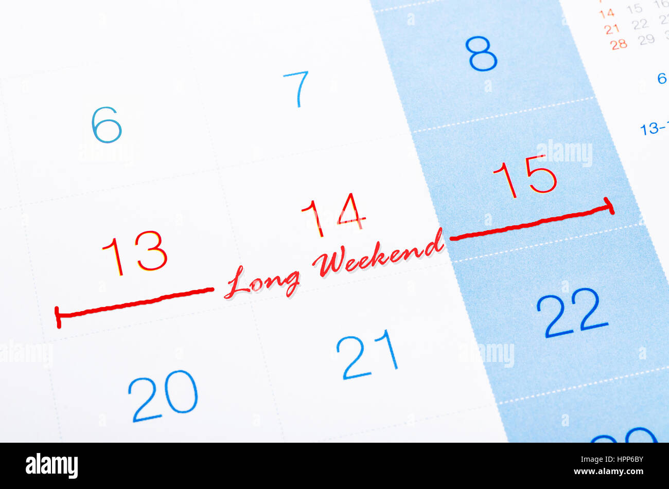 Concetto di immagine di un calendario con le parole lungo weekend per ricordarvi un importante appuntamento. Foto Stock