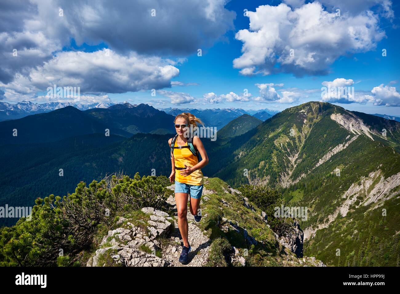 In Germania, in Baviera, giovane donna in corsa in montagna Foto Stock