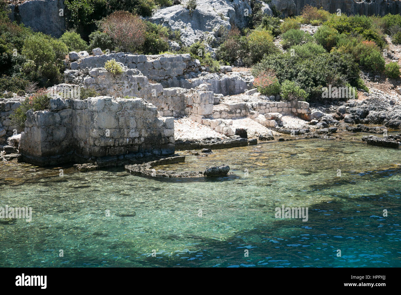 Città Sommersa di kekova nella baia di uchagiz vista dal mare in provincia di Antalya in Turchia con turqouise rocce del mare e il verde delle boccole con resti di antichi Foto Stock