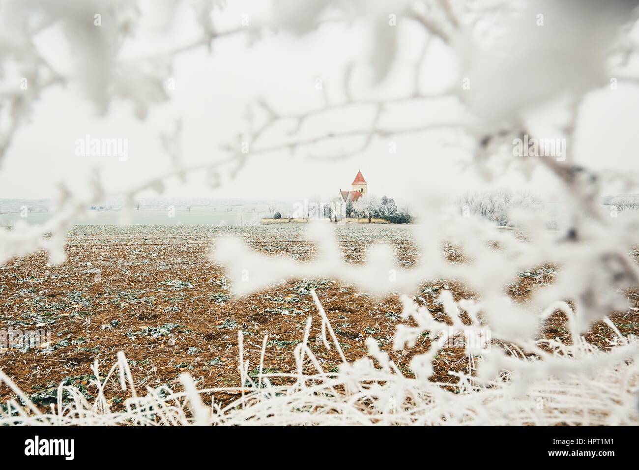 Piccolo cimitero con una chiesa in mezzo congelati paesaggio, Repubblica Ceca Foto Stock