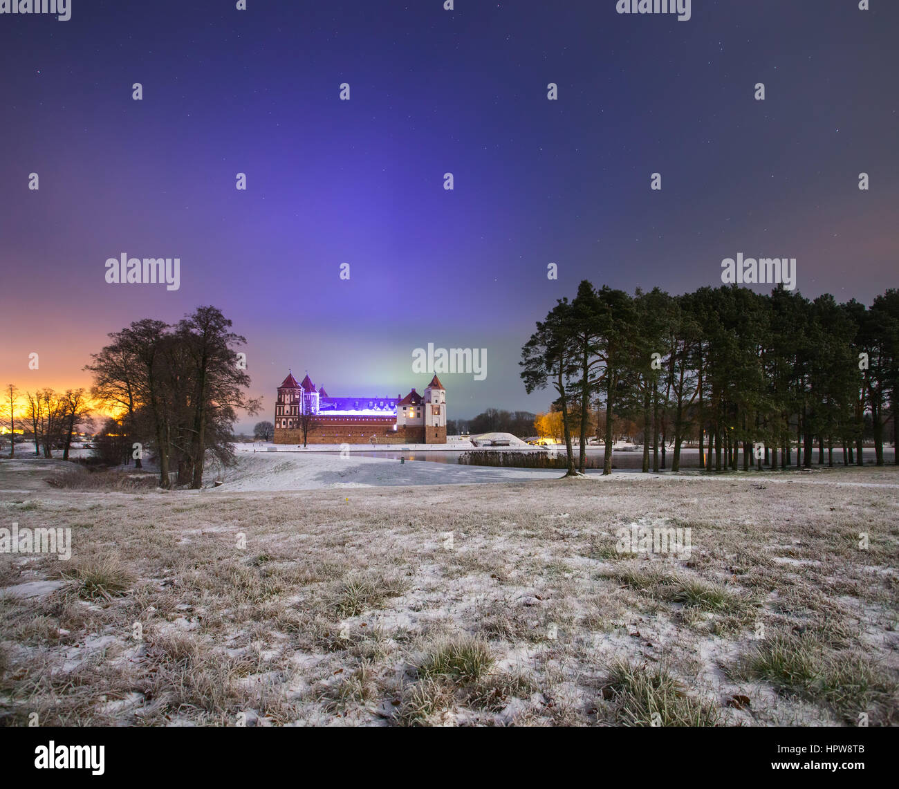Notte paesaggio invernale. Antico castello sul campo nevoso. Foto Stock