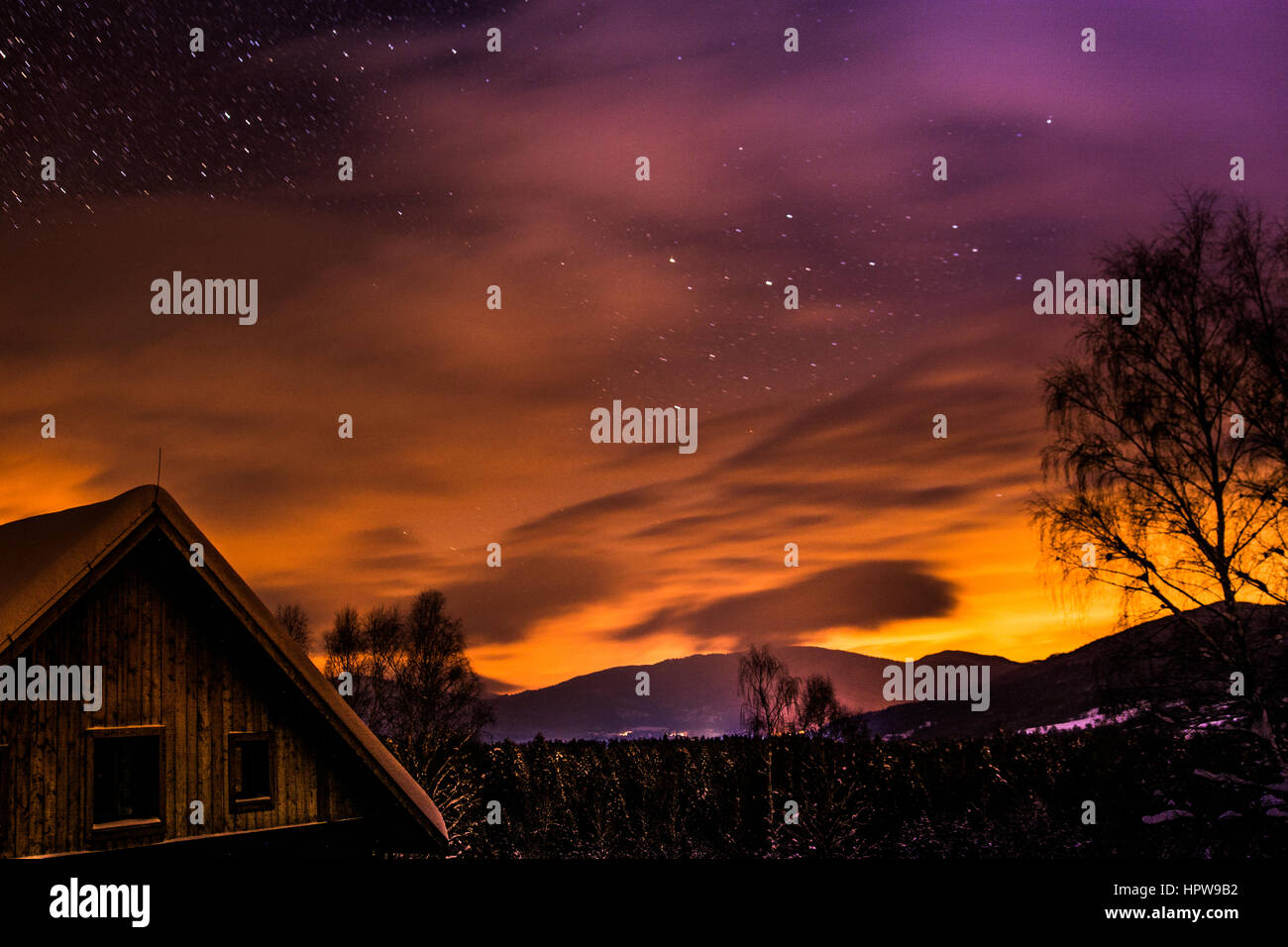 Cielo stellato sopra di uno chalet di montagna. I colori della natura durante la notte. Foto Stock