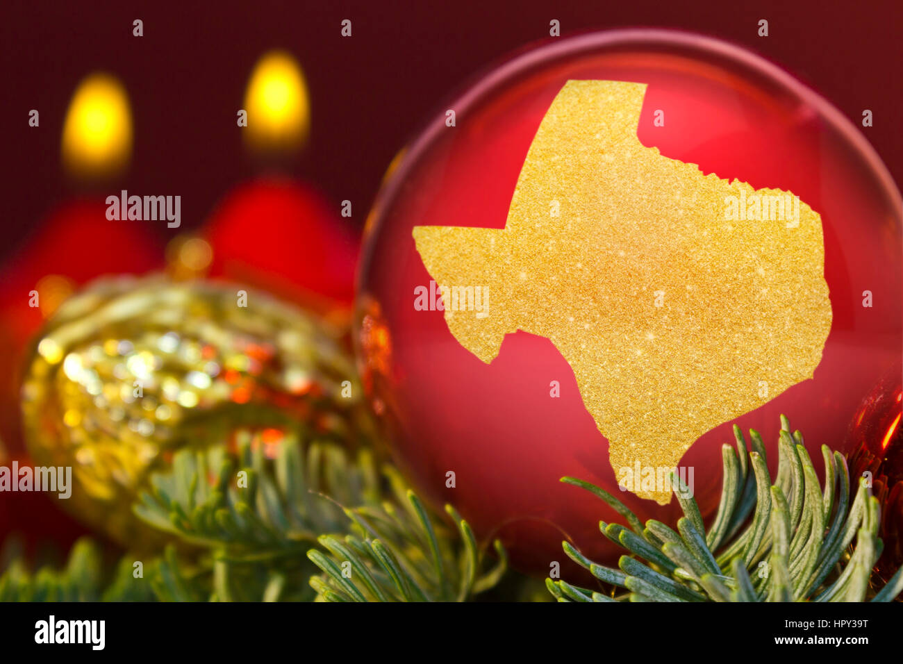 Un rosso lucido ninnolo con la forma d'oro del Texas.(serie) Foto Stock