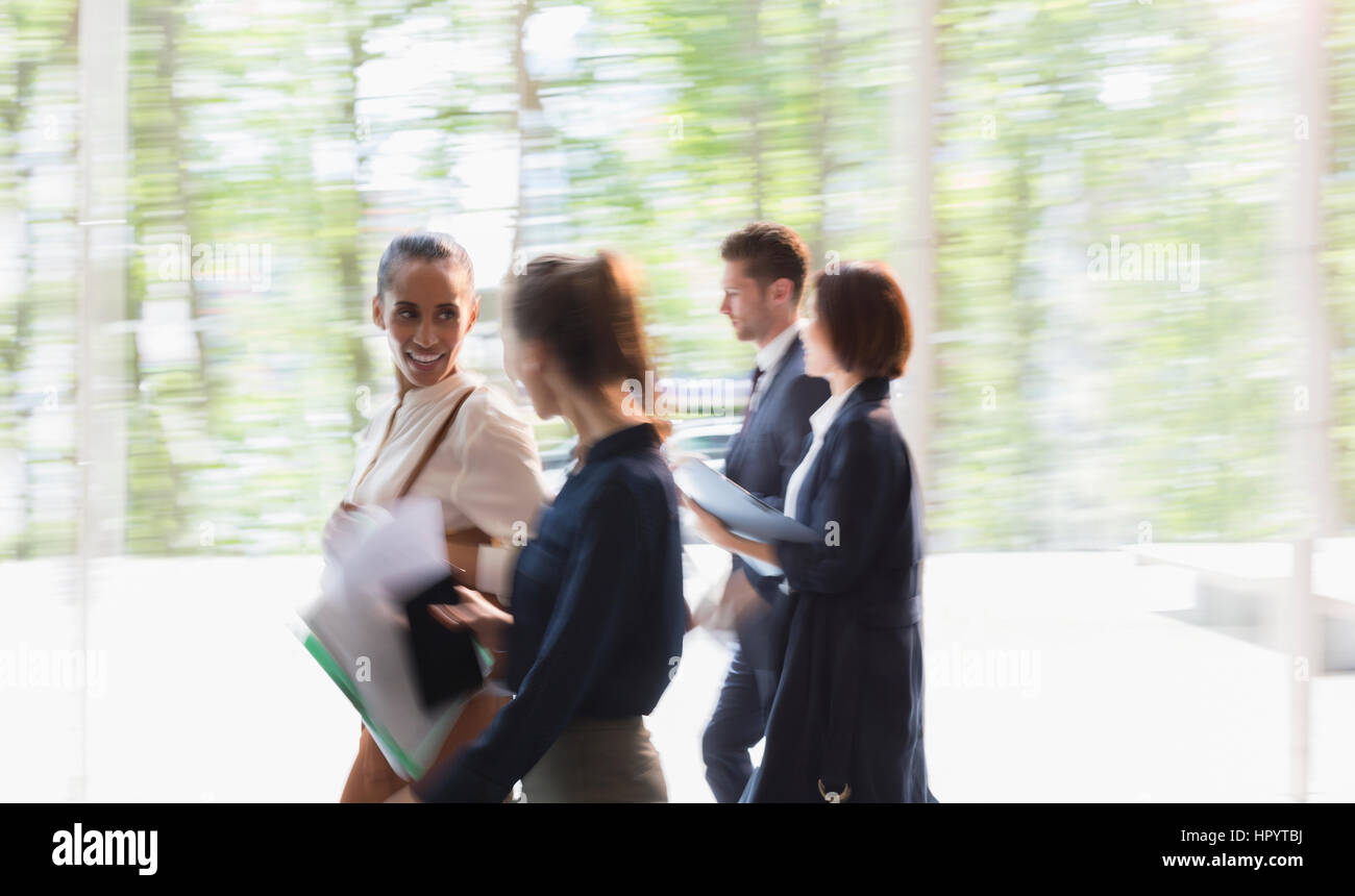 La gente di affari a piedi in movimento nella lobby di office Foto Stock