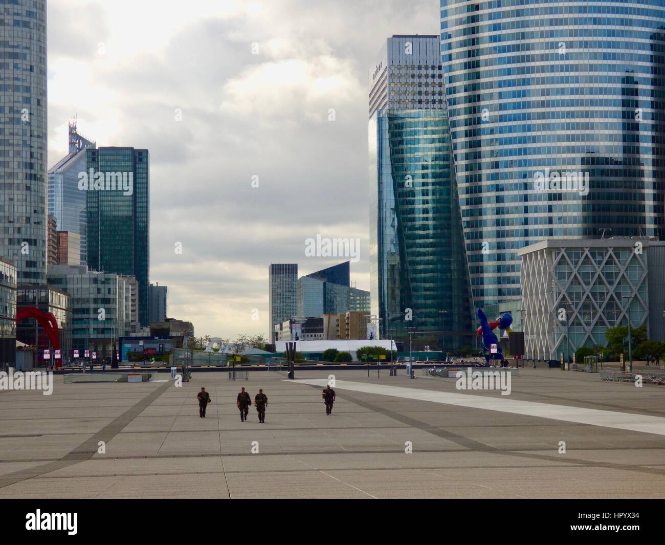 Quattro pesantemente armati militari pattugliano le deserte esplanade presso la Grande Arche a La Défense, inizio la domenica mattina. Parigi, Francia. Foto Stock