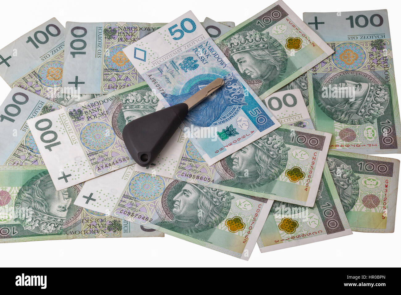 Le chiavi dell'auto sul zloty polacco banconote background closeup isolato su bianco Foto Stock