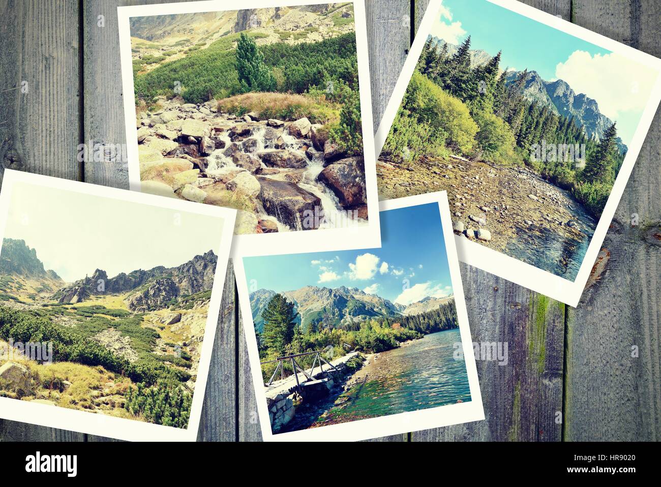 Mucchio di vintage foto dalle vacanze in montagna con un tradizionale telaio bianco posizionato sulla scrivania in legno. Foto Stock