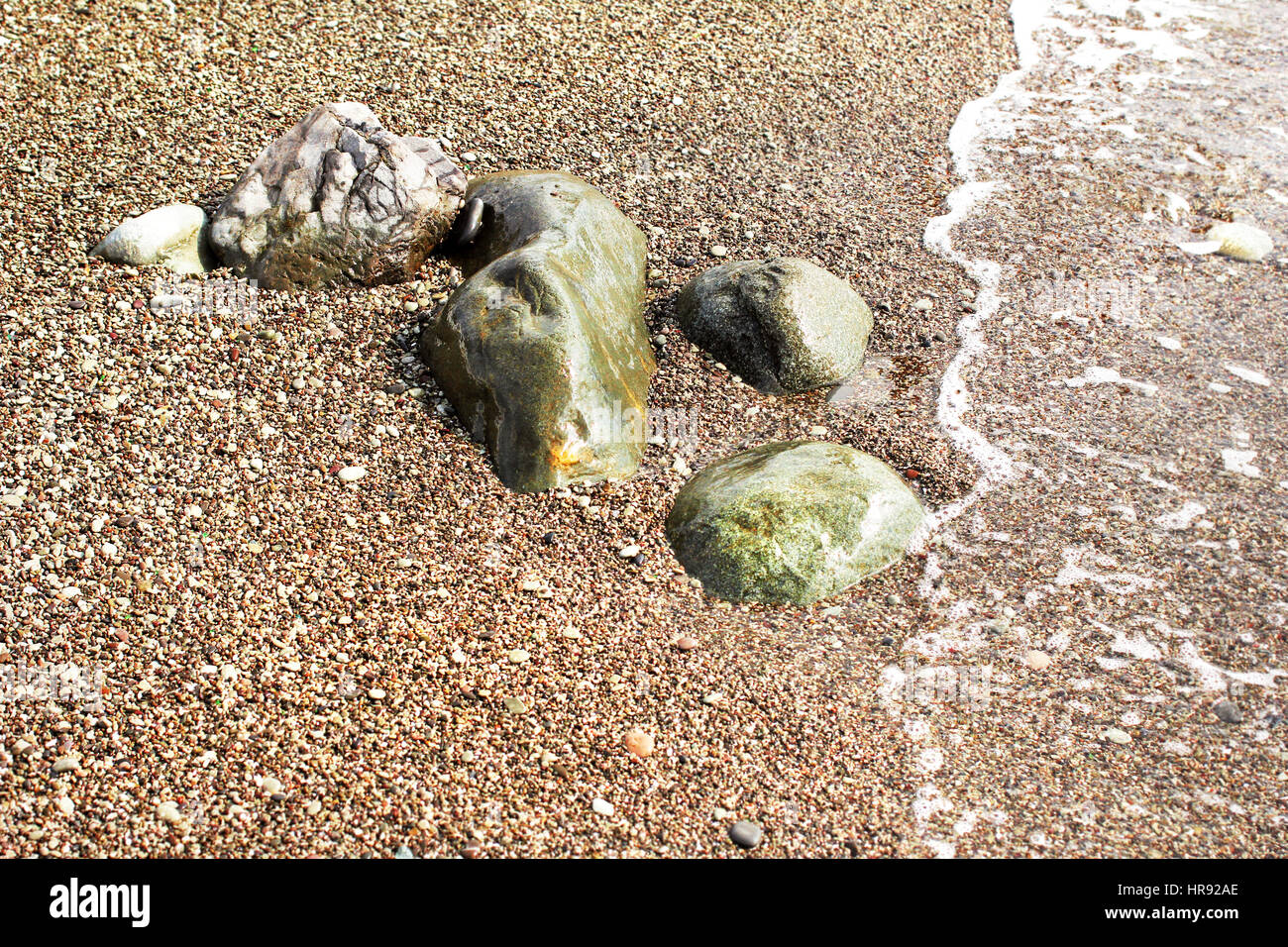 Grosse pietre sulla riva del mare al giorno di sole Foto Stock