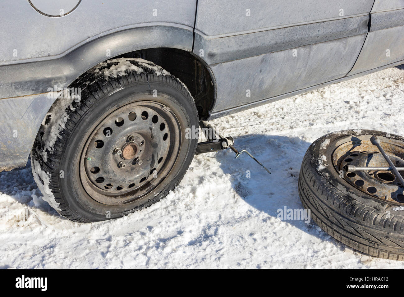 Modifica di un pneumatico sgonfio in inverno la neve con il backup Foto Stock