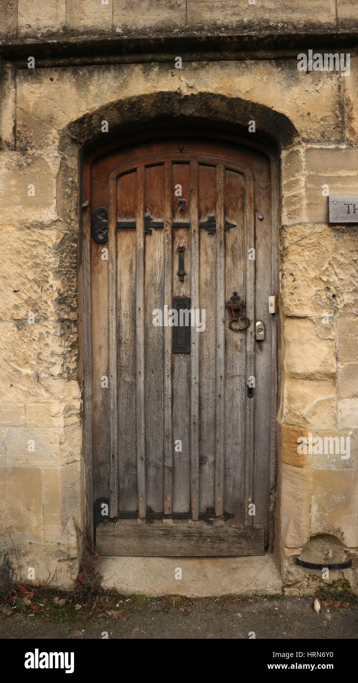 Vecchia porta di legno su una pietra di Cotswold House close up, England, Regno Unito Foto Stock