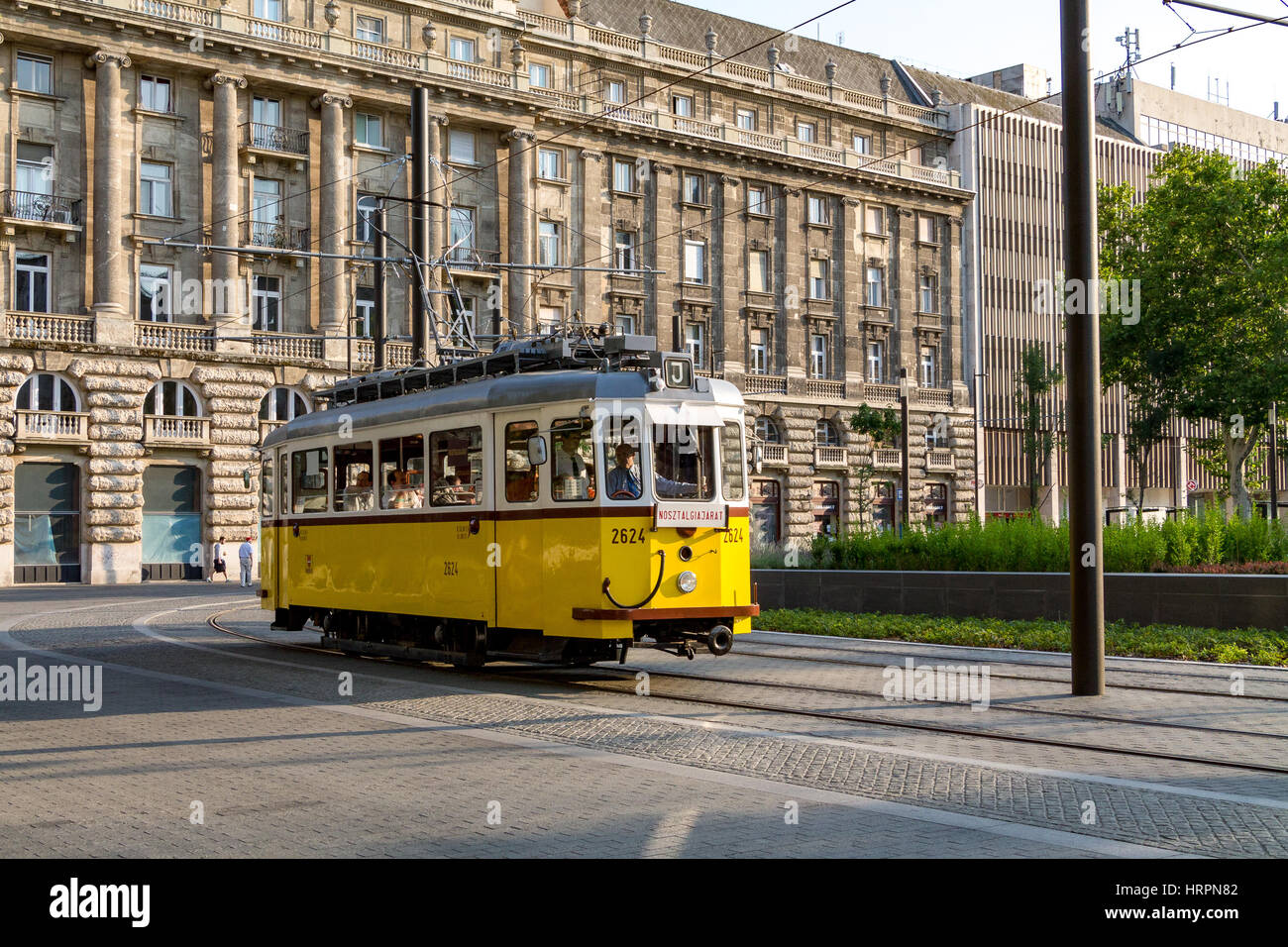 Un vecchio tram che arriva dietro un angolo sul Kossuth ter a Budapest, Ungheria Foto Stock