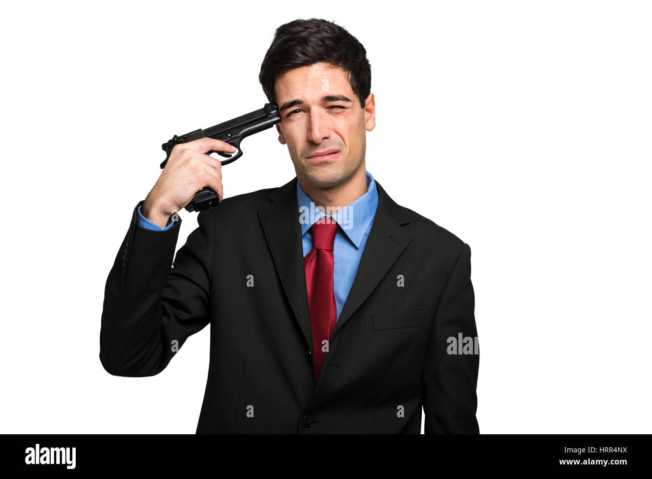Giovane uomo nel business suit con la pistola cercando di rendere il suicidio Foto Stock