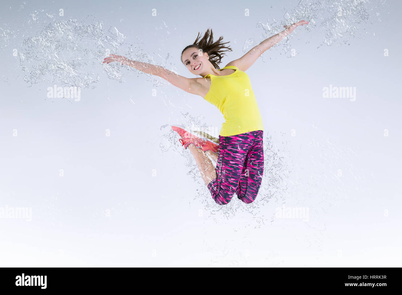 Donna in salto. Movimento congelato. Manipolazione Della Foto spruzzi d'acqua Foto Stock