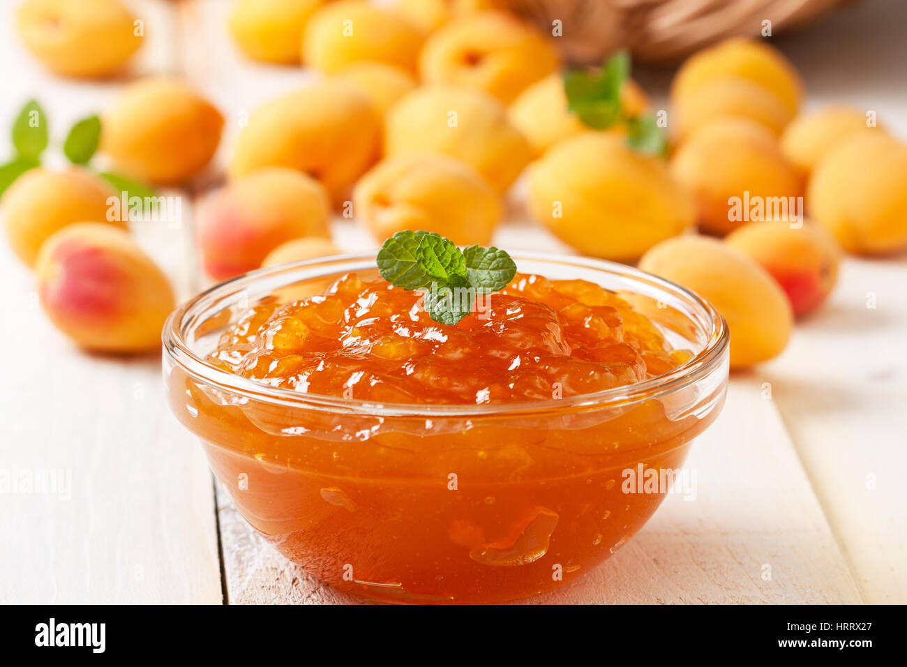 Confettura di albicocche in una ciotola di vetro , fresche Albicocche su sfondo di legno Foto Stock