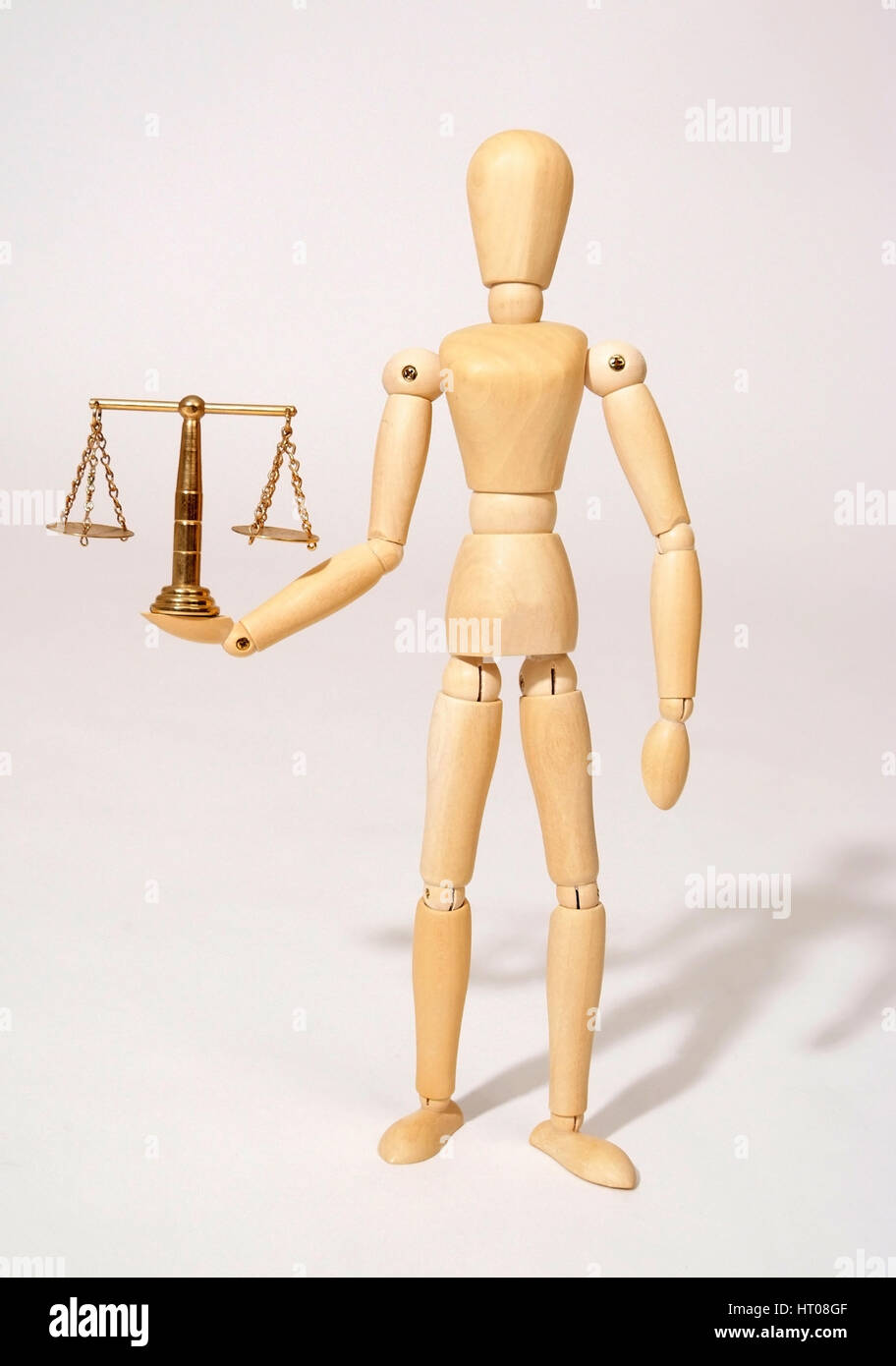Holzpuppe mit Messingwaage, Symbolbild Gerechtigkeit - bambola articolata con scala Foto Stock