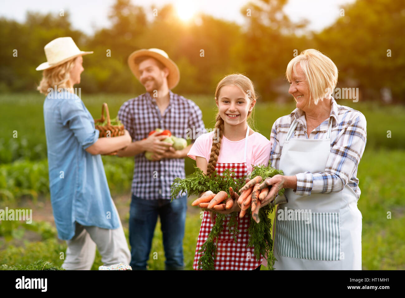 Soddisfatto della famiglia rurale con propri prodotti vegetali Foto Stock