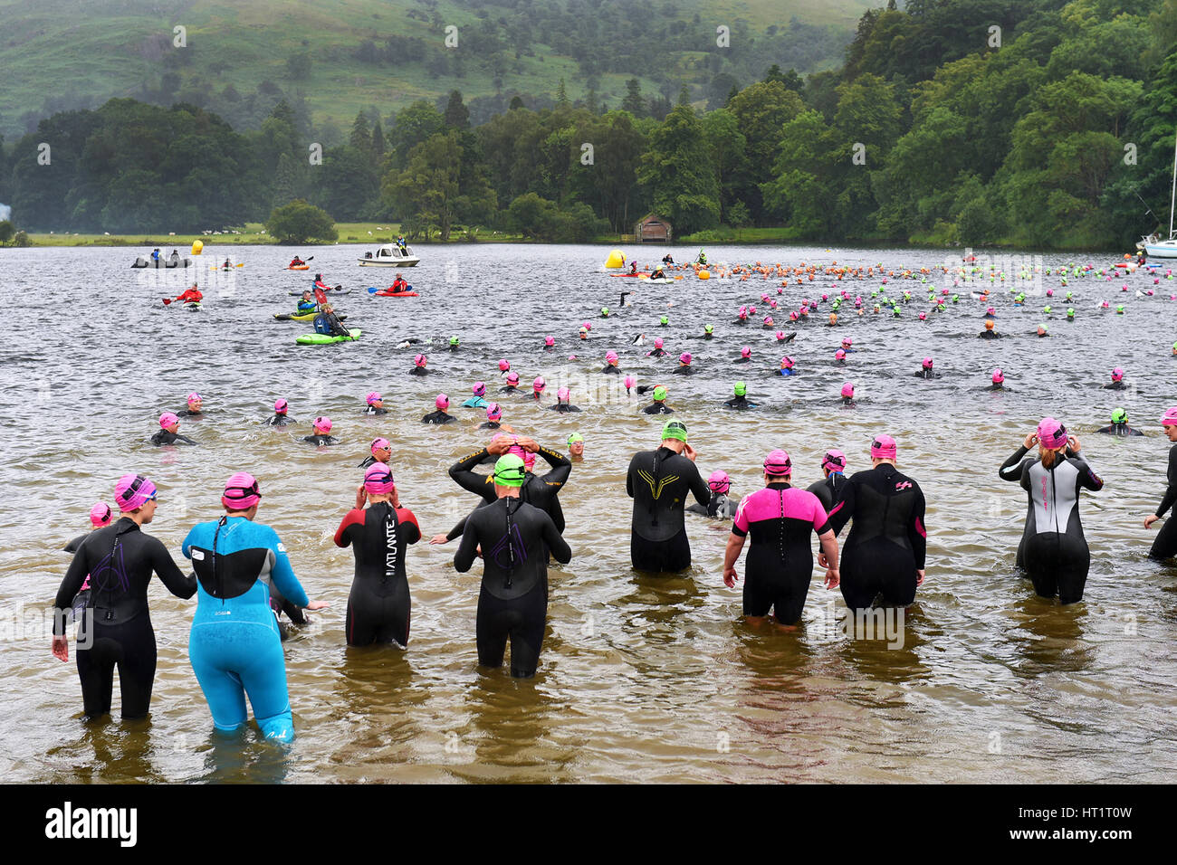 Nuotatori wade in Ullswater lago per nuotare un miglio, Cumbria Regno Unito Foto Stock