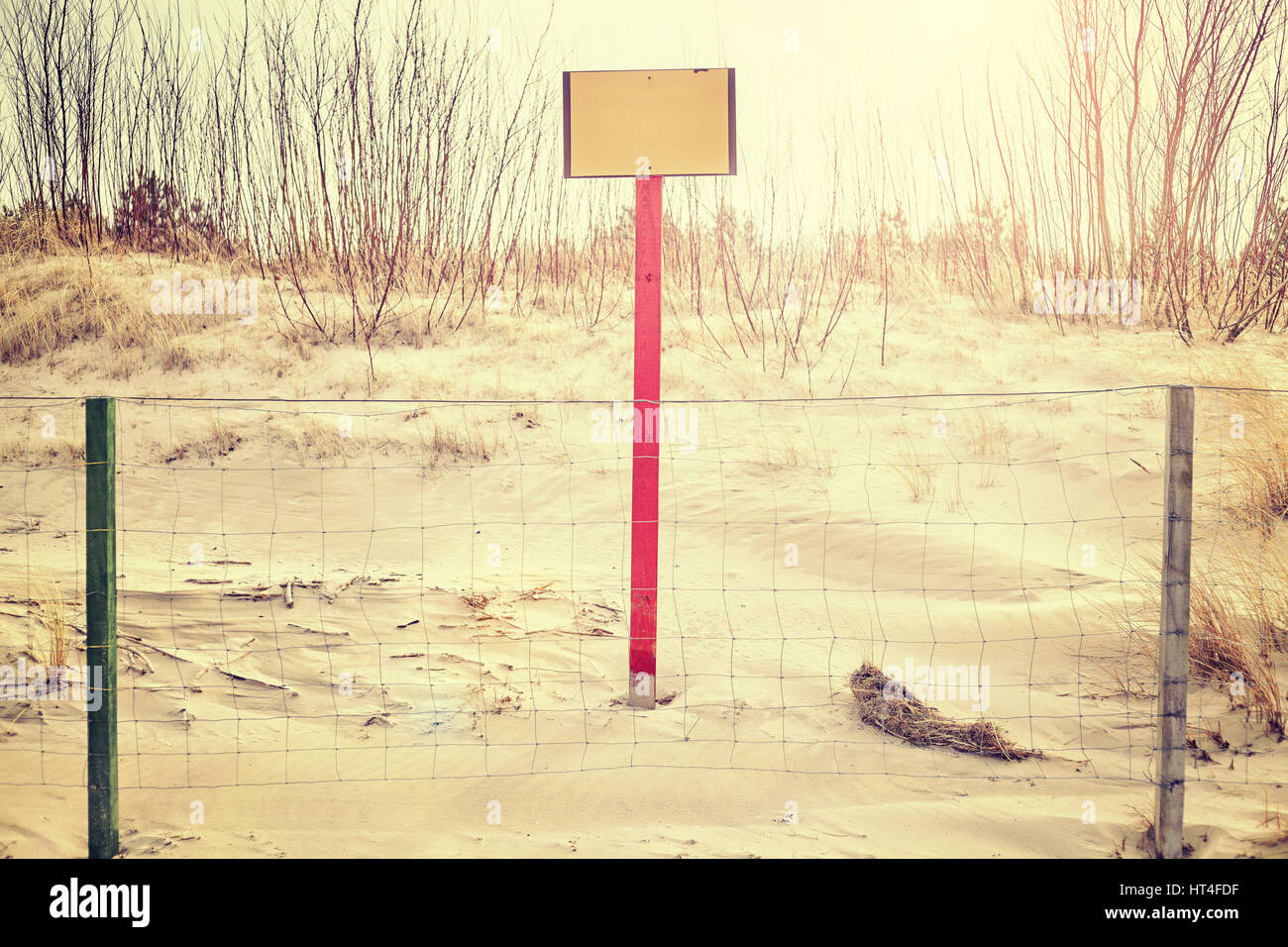 Segno sulla duna di spiaggia dietro un recinto, spazio per testo, dai toni di colore foto, messa a fuoco selettiva. Foto Stock