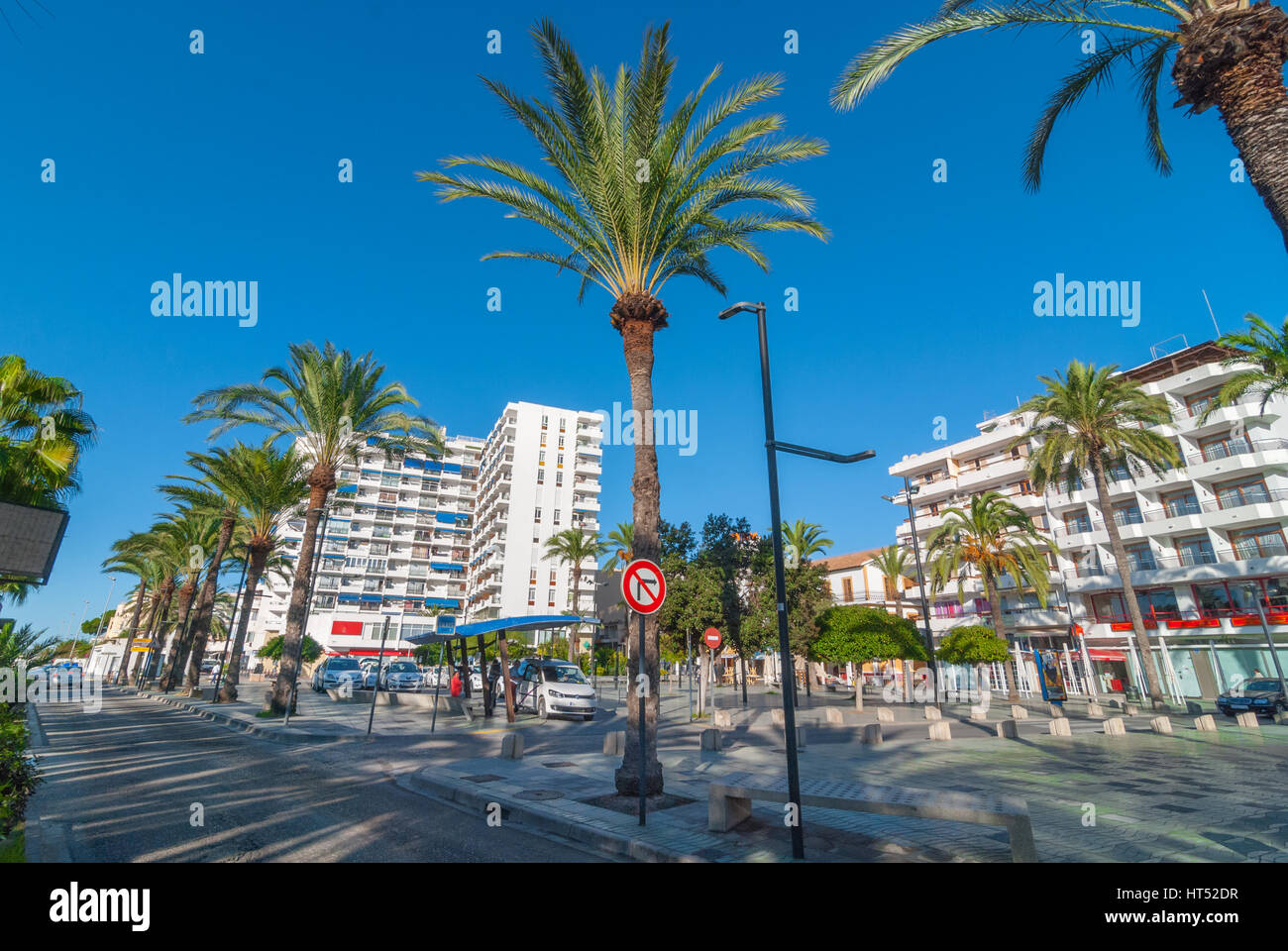 Sant Antoni de Portmany, Ibiza, Novembre 6th, 2013: Turismo in Spagna. La gente in attesa in corrispondenza di una stazione dei taxi. Fiancheggiata da palme parco pedonale & fontana. Foto Stock