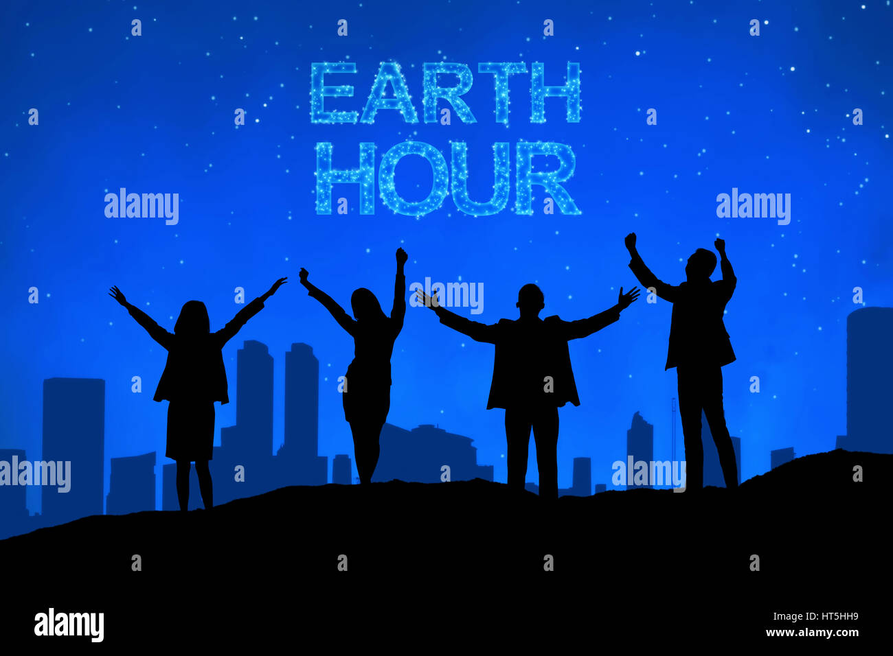 Silhouette di gente di affari con messaggio Earth Hour di notte Foto Stock