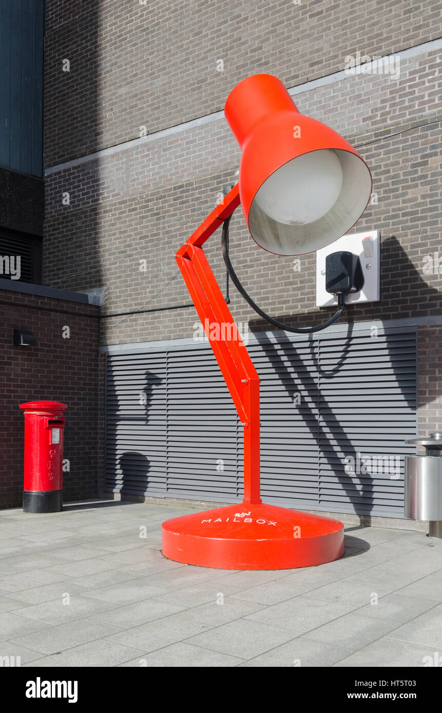 Grandi anglepoise rosso lampada da scrivania accanto a una dimensione normale casella di posta al di fuori della casella postale in Birmingham Foto Stock