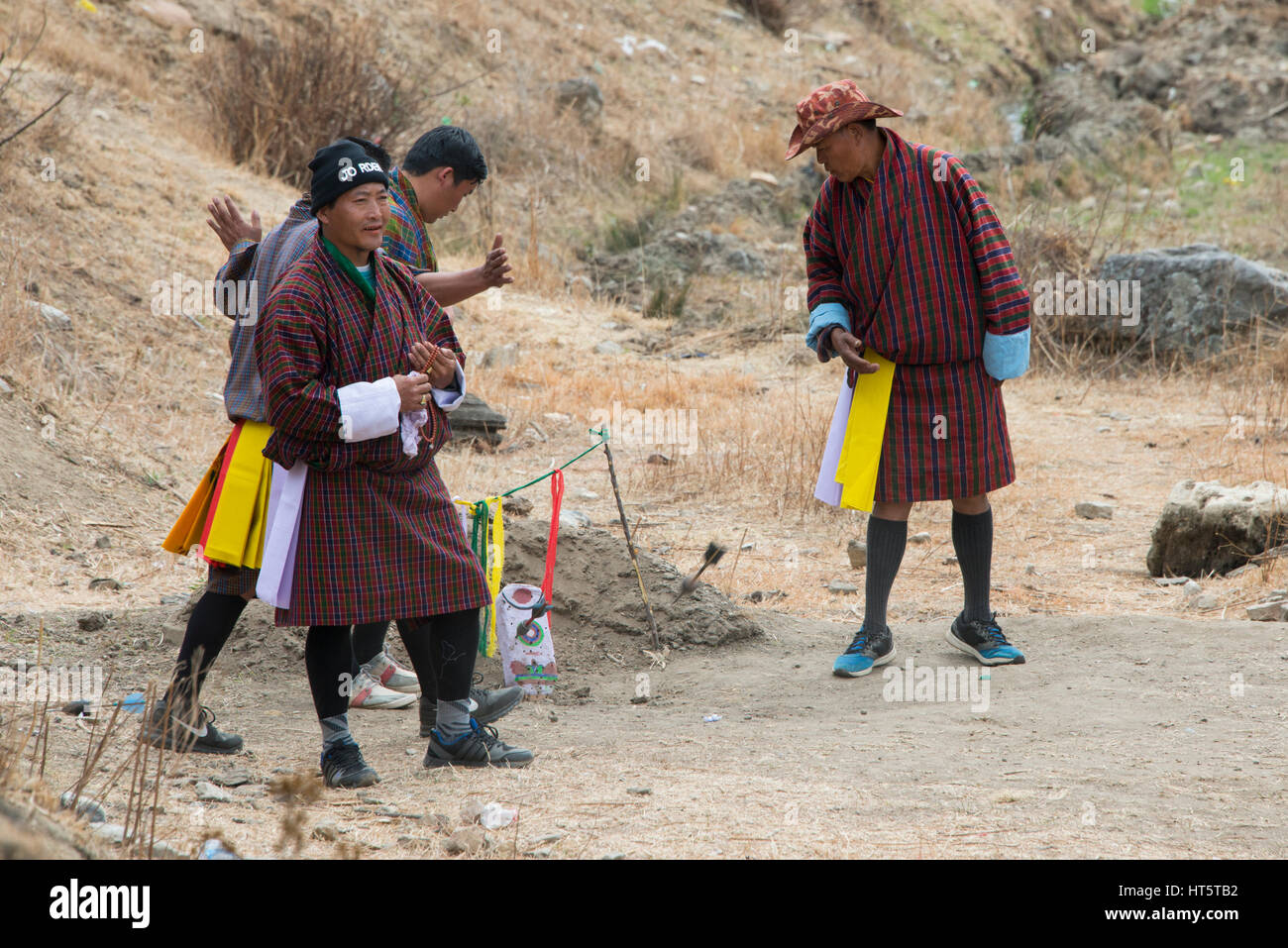 Il Bhutan, Paro. Khuru (freccette) tradizionale sport bhutanesi di lanciare freccette di grandi dimensioni all'aperto, dart in target. I giocatori in costumi tradizionali. Foto Stock