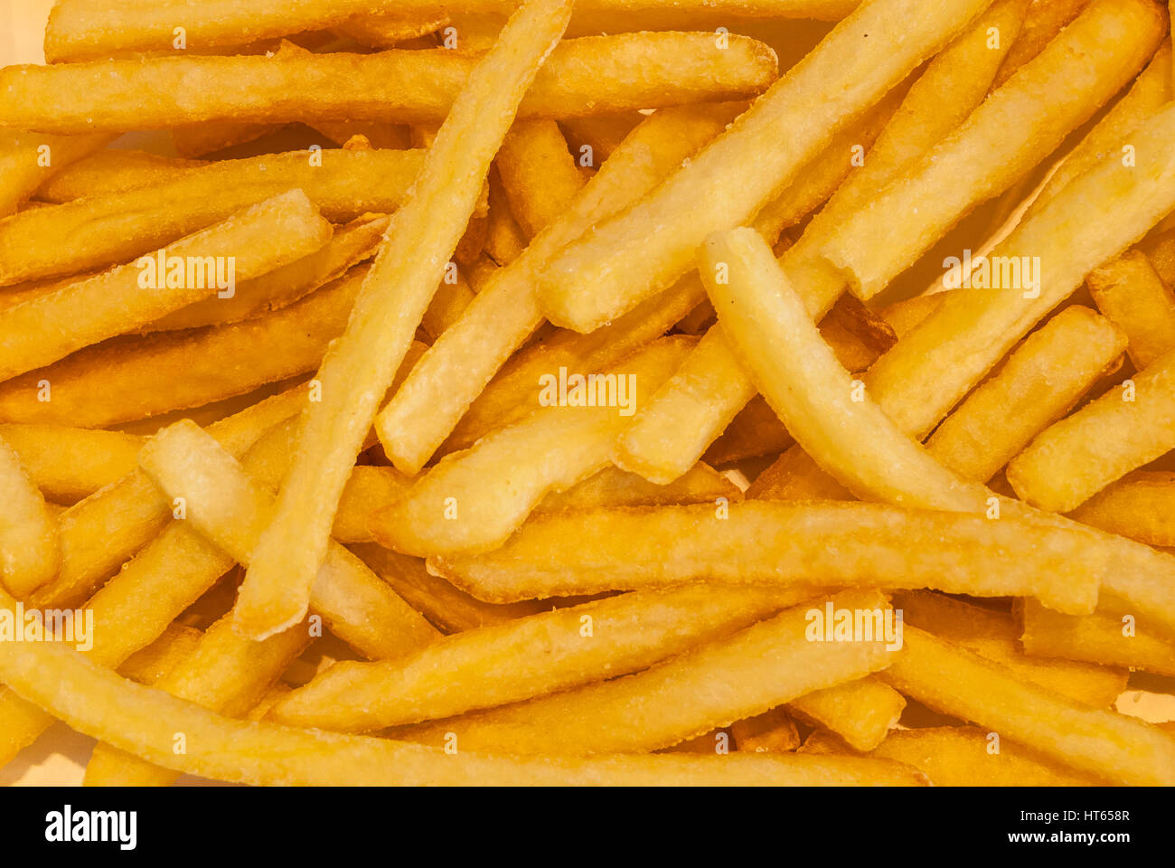 Primo piano di patatine fritte, alta calorie cibo spazzatura, sfondo Foto Stock