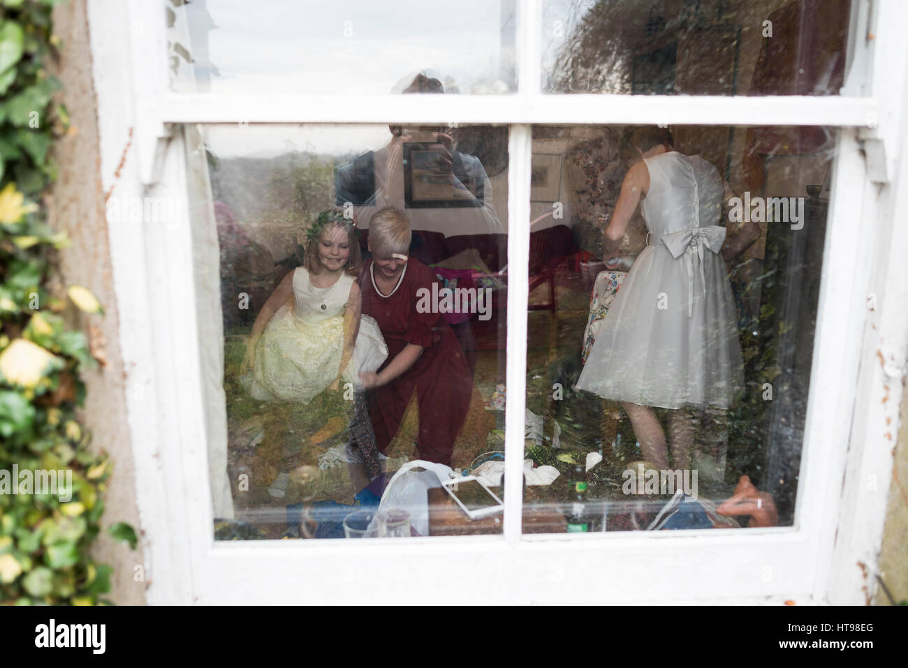 Bridesmaids ottenere pronto fotografato attraverso una finestra Foto Stock