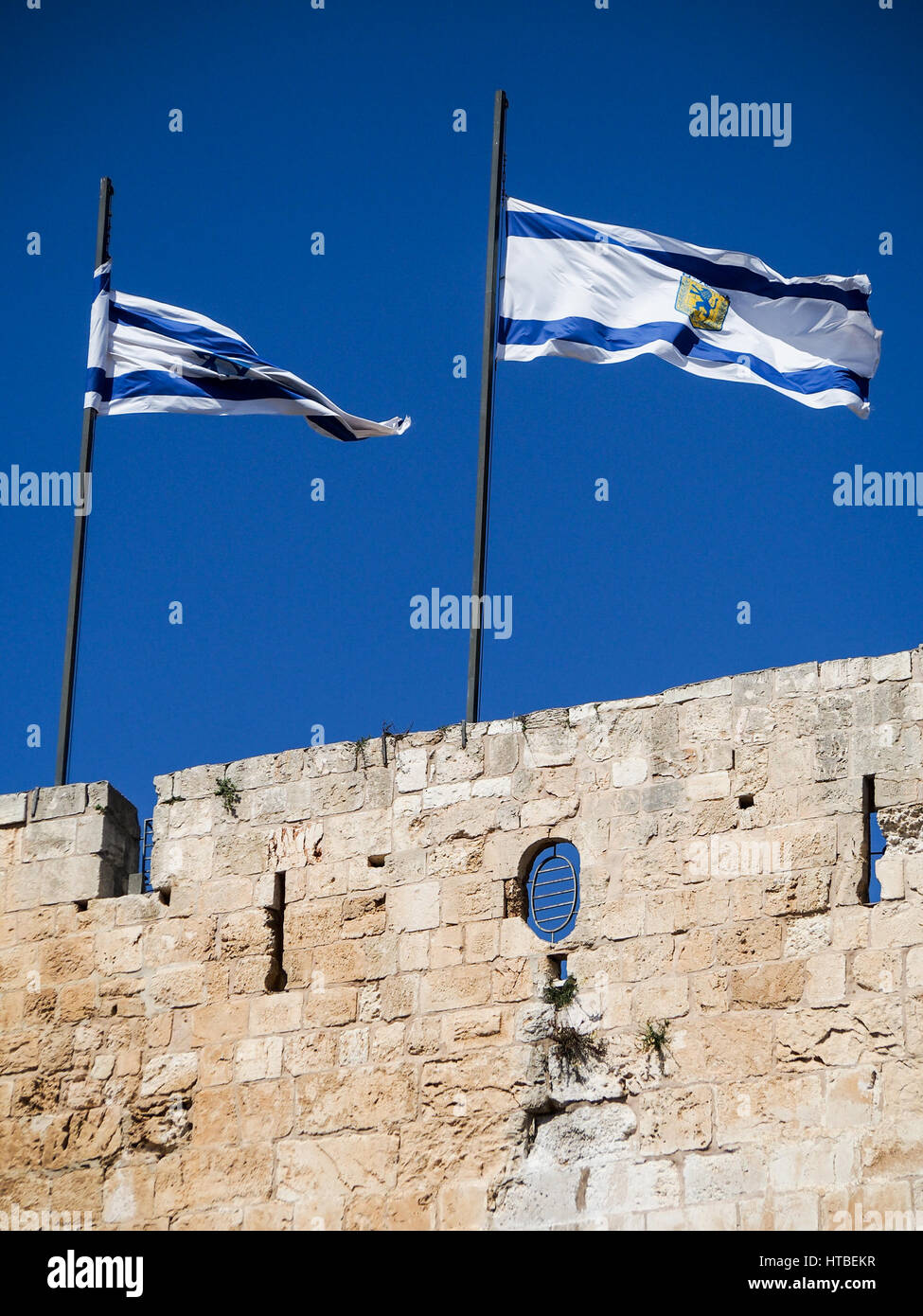Bandiere volare oltre il muro che circonda la città vecchia di Gerusalemme, Israele. Foto Stock
