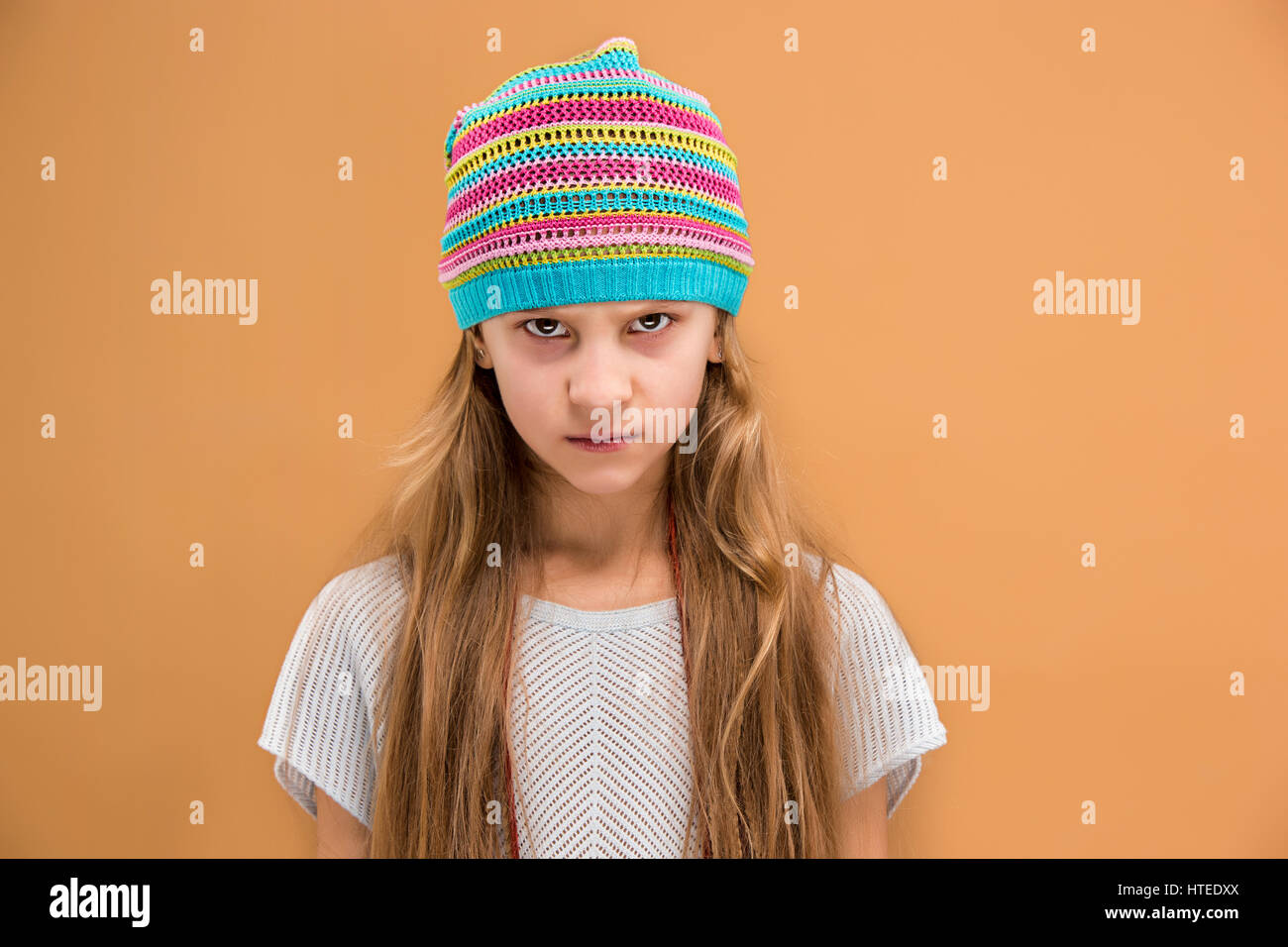 Angry Young girl in hat guardando la fotocamera con odio Foto Stock