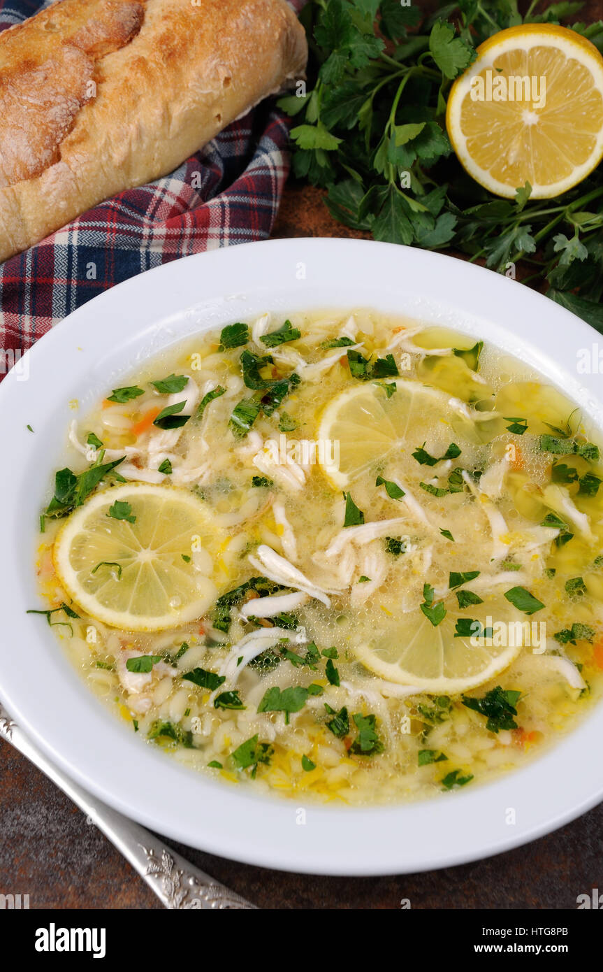 Avgolemono, greca zuppa di pollo con uova di salsa di limone, orzo e fresche foglie di prezzemolo Foto Stock