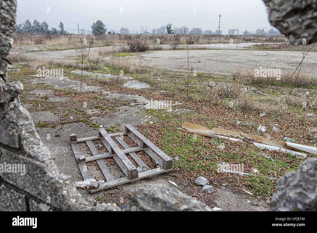 Vecchio pallet danneggiati, concetto di fallimento aziendale, vista attraverso il muro rotto Foto Stock