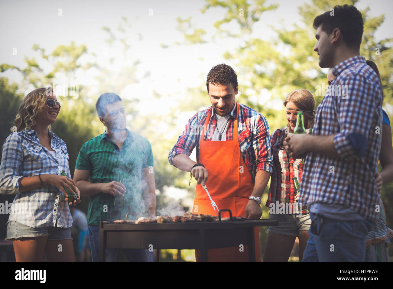 I giovani in natura avente un barbecue party Foto Stock