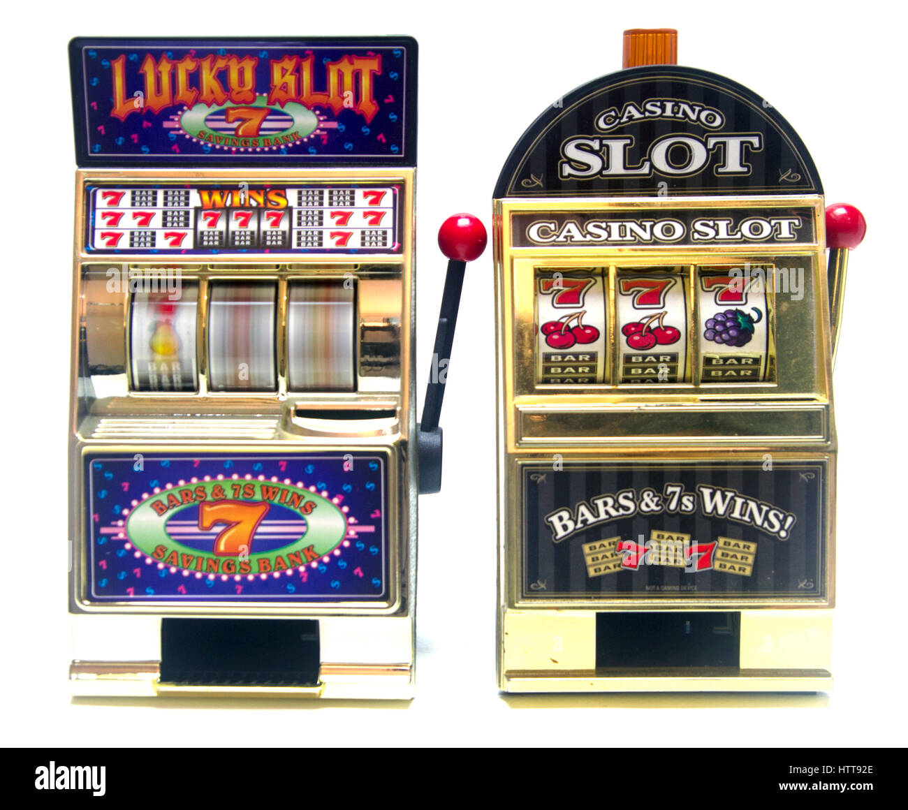 Due giocattolo vintage slot machines con denaro in oro Foto Stock