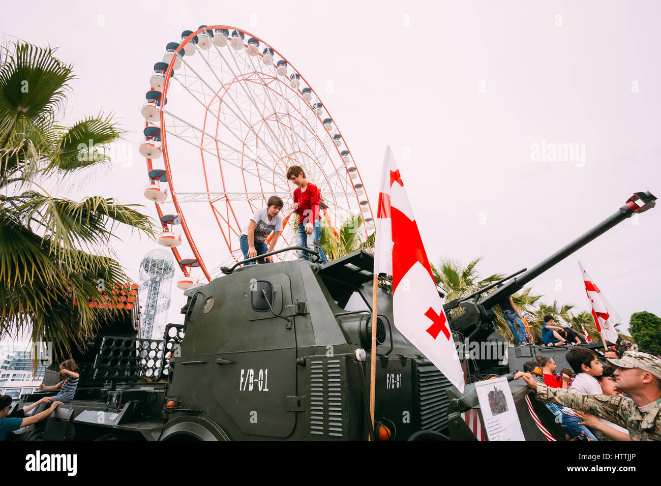 Batumi, Adjara, Georgia - 26 Maggio 2016: Bambini salendo su un mezzo semovente a unità di artiglieria a una mostra di armi durante la celebrazione della NAT Foto Stock