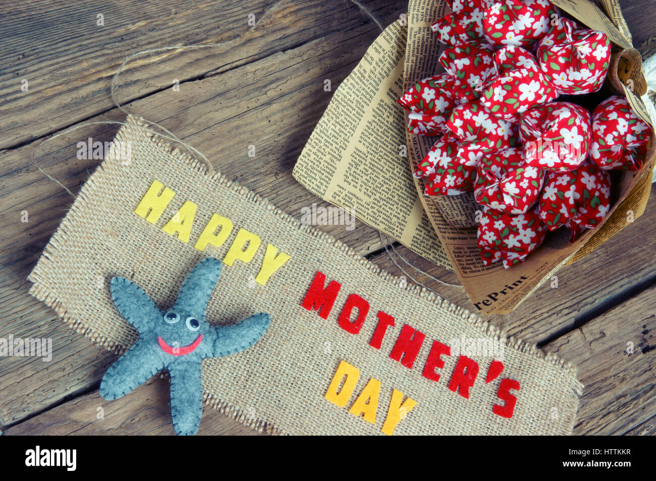 Felice Festa della mamma con ti amo mamma messaggio, idea dal tessuto colorato starfish su sfondo di legno, bel fiore, abstract texture di legno, Foto Stock