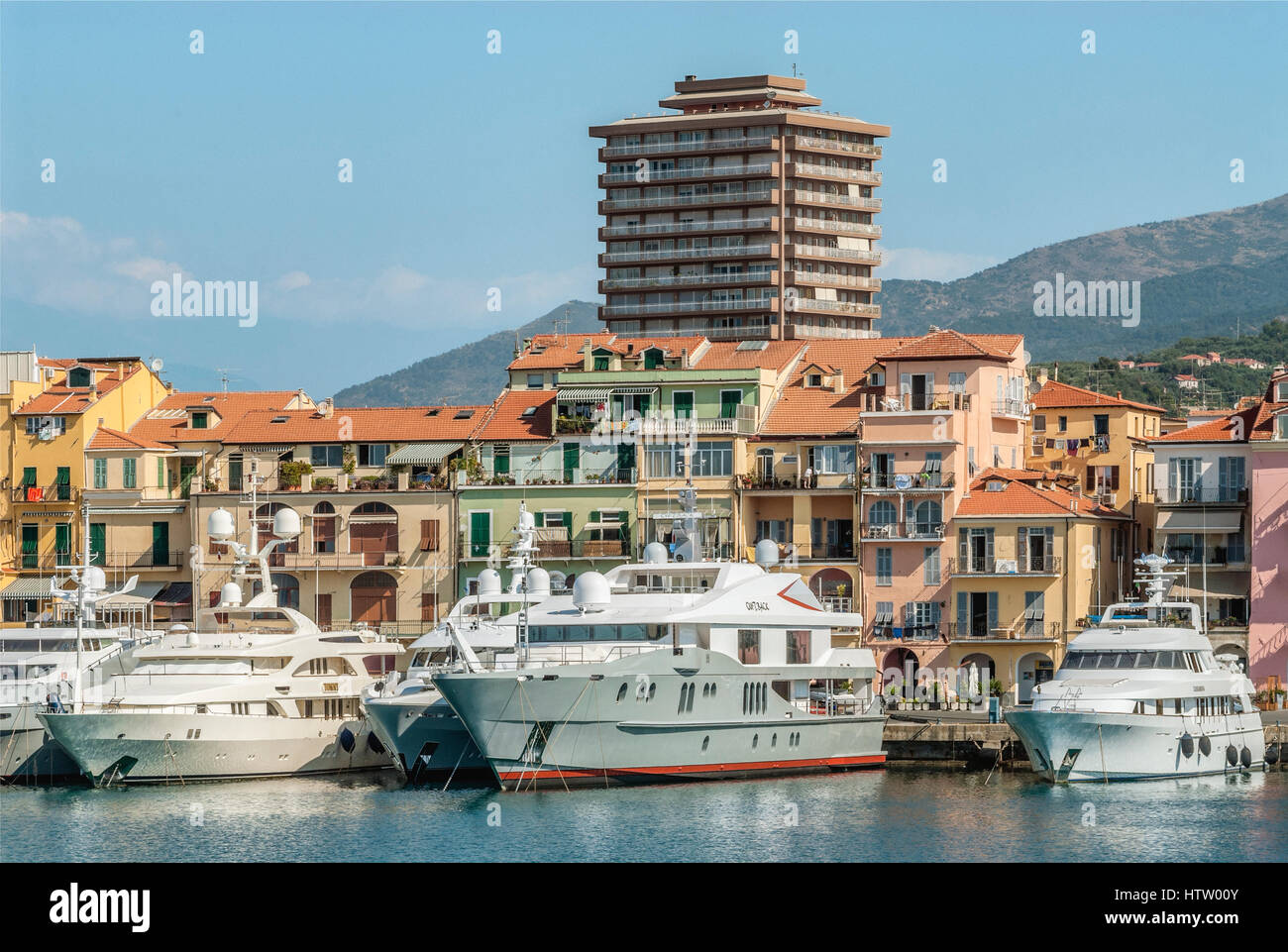 Yacht di lusso di fronte alla città vecchia nel porto di Oneglia di Imperia Liguria, Italia. Foto Stock