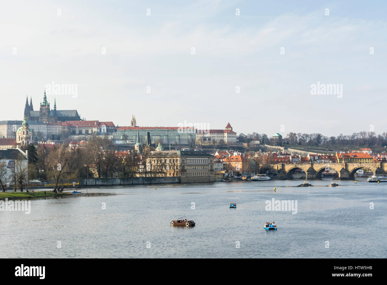 I turisti in pedalò nel fiume Moldava, il ponte Carlo e il Castello di Praga. Praga Repubblica Ceca, Europa Foto Stock