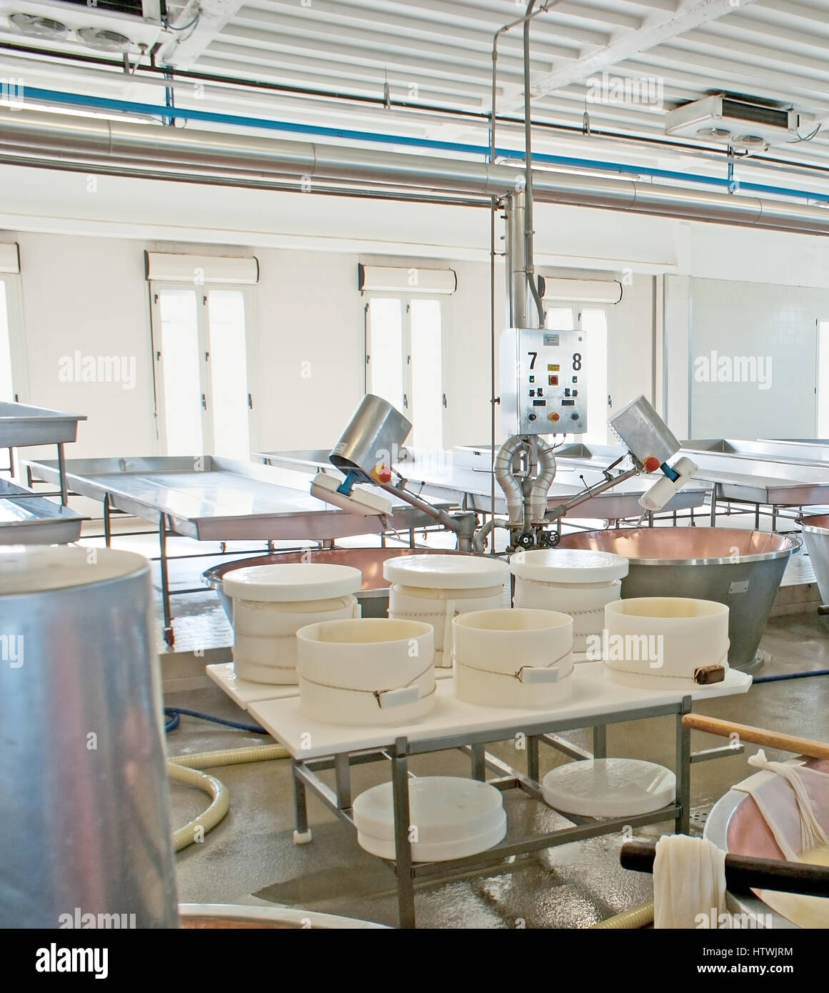 PARMA, Italia - 24 Aprile 2012: Il formaggio manifattura di fermentazione del Caseificio la Traversetolese impianto con rame bollitori e secchielli in plastica per Foto Stock