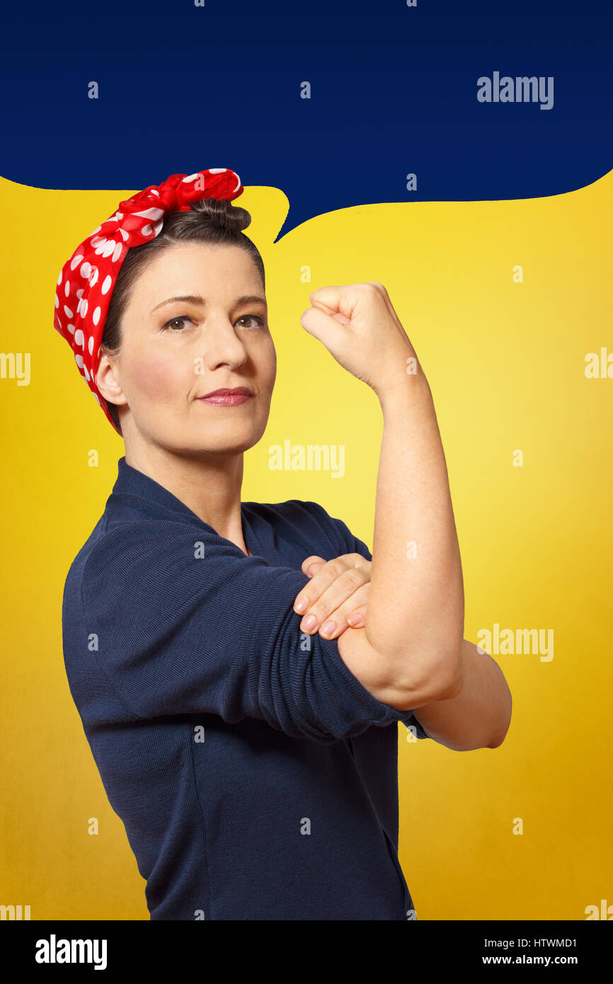 Robusto e sicuro di sé una donna con il pugno chiuso arrotolando il suo manicotto, vuoto discorso bolla con lo spazio di testo, omaggio a icona americana Rosie chiodatrice Foto Stock